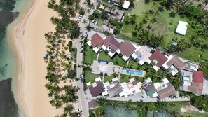 An aerial view of a resort with multiple buildings, a swimming pool, and a beach. - Beach Paradise: 2-bedroom condo in delightful Las Terrenas with AC (Las Terrenas)