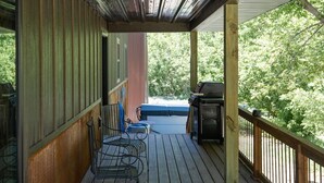 A wooden deck with a grill and chairs, overlooking a wooded area. - Deadwood Cabin-Sleeps 12-Hot Tub-4X4 Trails-Central (Deadwood)