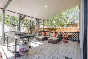 An outdoor patio with a grill, seating area, and a table. - NEW! Starlight Stay | Outdoor Oasis w/ Game Room! (Fruita)