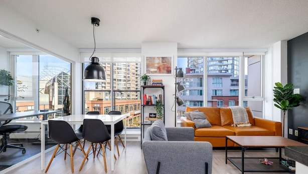 A modern living room with a dining area, large windows, and a city view. - Downtown Luxurious 2BD|Pool |Parking|Hot Tub|Sauna (Vancouver)