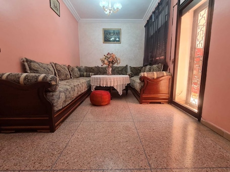 Interior. Cozy Villa bedroom with balcony : private bath accessed via shared space.