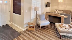 A living room with a sofa, armchair, and a small wooden stool. - Vineyard Getaway 3BR Home in Lodi minutes away from shopping & attractions (Lodi)