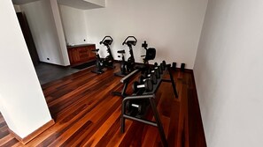 A home gym with exercise equipment including a treadmill, stationary bike, and weight bench. - Quiet luxury among the olive groves of Orvieto (Orvieto)
