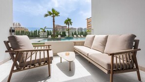 A balcony with a sofa, two chairs, and a small table. - Free Housekeeping Visits During Your Stay - Stayshort - Comfortable Studio Stay in Arjan Sleeps 2 With Balcony (Dubai)