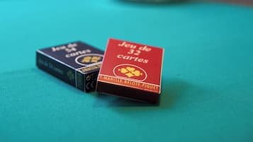 Two card boxes on a teal surface with a blurred background.