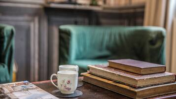 A table with a mug, books, and a magazine.