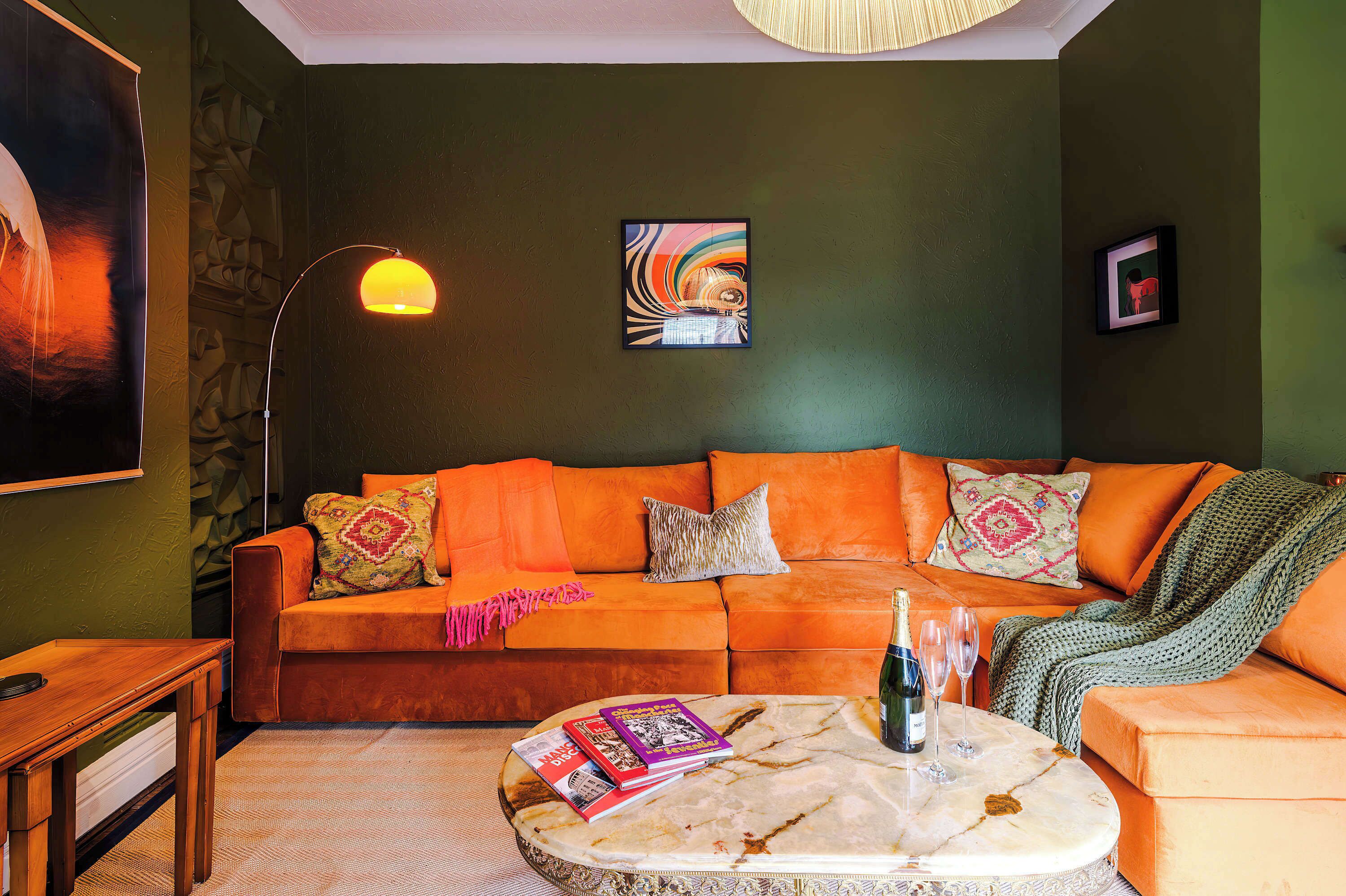 The retro styled living room features a large corner sofa, perfect for relaxing in the evening. The ambience of the room is a total experience, allowing you to relax with a good book or appreciate the tasteful artwork and enjoy some records playing!