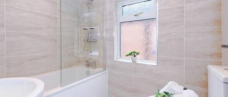 Shower, hair dryer, towels, shampoo
