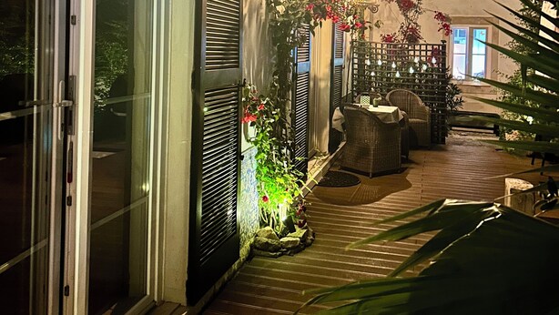 A building with a covered outdoor area, a glass door, and a wall-mounted light fixture. - Do Padre - a relaxing vacation in the heart of Portugal - our "Lisbon Apartment" (Brogueira)