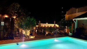 A pool area with a tiled floor, surrounded by outdoor seating and potted plants. - Do Padre - a relaxing vacation in the heart of Portugal - our "Lisbon Apartment" (Brogueira)