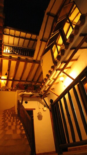 A staircase with wooden railings and a checkered floor pattern.