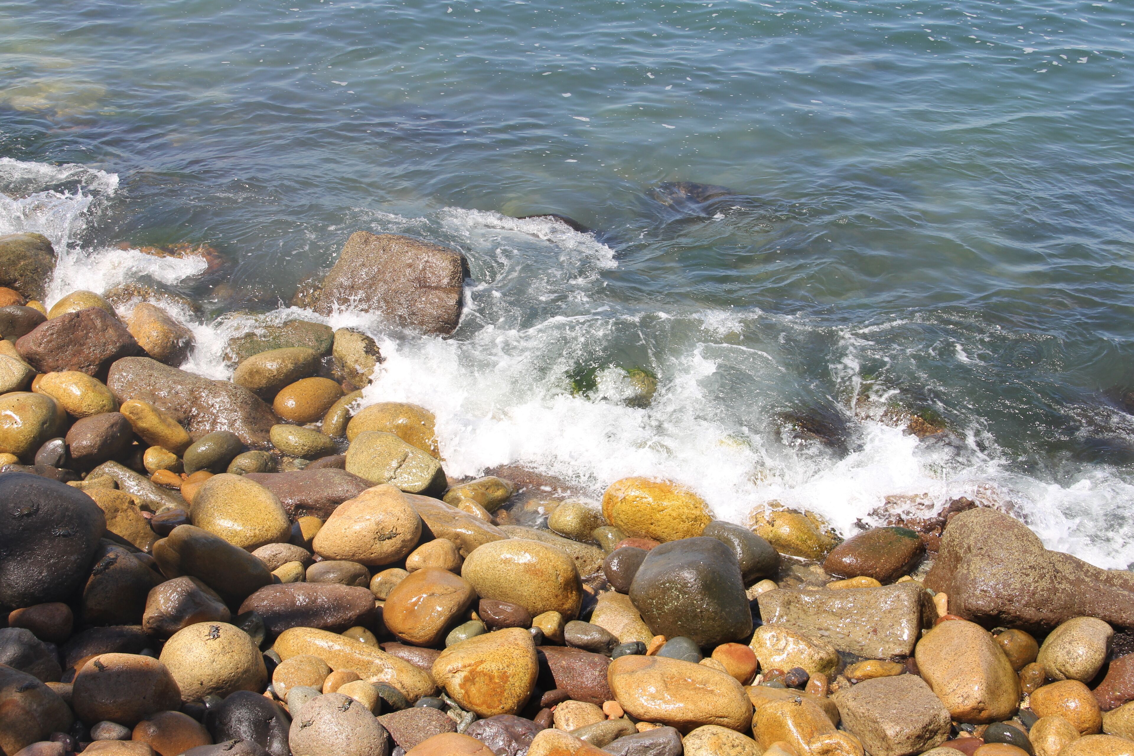 A rocky shoreline with waves crashing against the rocks.