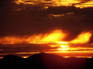 A sunset over a mountainous landscape. - Onyx Suite (Victoria)