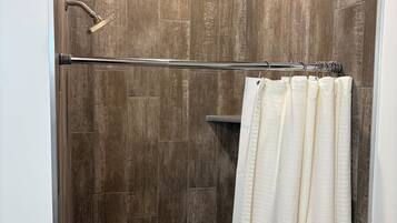 Chuveiro, toalhas de banho, sabonete, shampoo