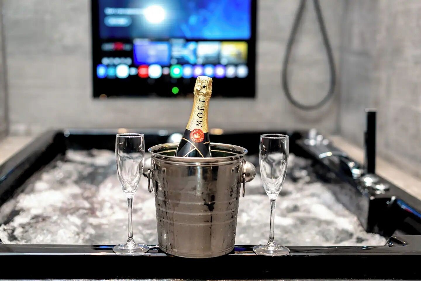 A minibar with a bottle of Moët champagne and two glasses.