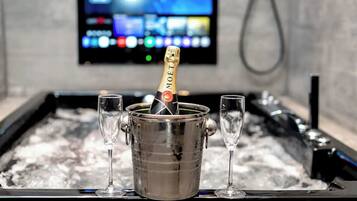 A minibar with a bottle of Moët champagne and two glasses.