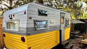 A vintage camper with a sliding door, a small window, and a side step. - Ms Buttercup is Close to Downtown and Savannah Bananas! (Savannah)