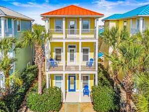 A multi-story building with a balcony, surrounded by palm trees. - Fall Deals + Snowbird Rates | Coastal Stay Near the Beach (Panama City)
