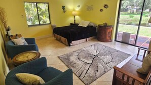 A living room with a sofa, a coffee table, a rug, and a bed. - Pet friendly, waterfront property on a canal off of the Caloosahatchee River (Fort Myers)