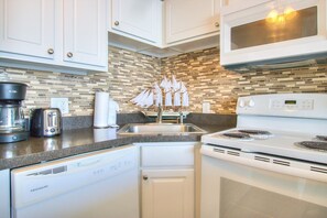 Fridge, microwave, oven, stovetop - Experience oceanfront bliss in this 2BR retreat at Carolina Beach! (Carolina Beach)