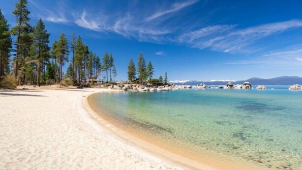 A beach with clear water, sandy shore, and trees. - Wooded Cabin Perfect for South Lake Tahoe Day Trips (El Dorado County)