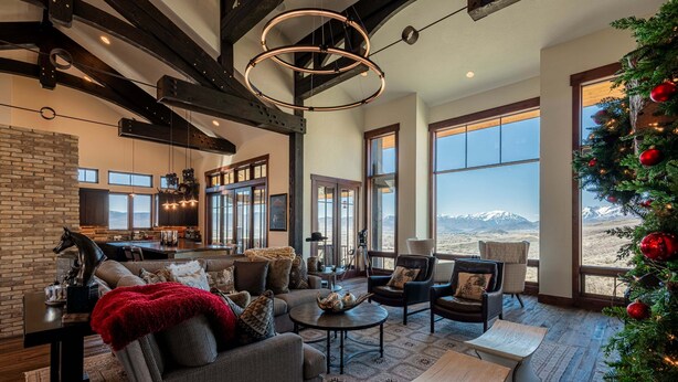 A spacious living area with a fireplace, large windows, and a view of the mountains. - Spacious 4BR home in Midway River Meadows (LT), perfect for adventures in Park City. (Midway)
