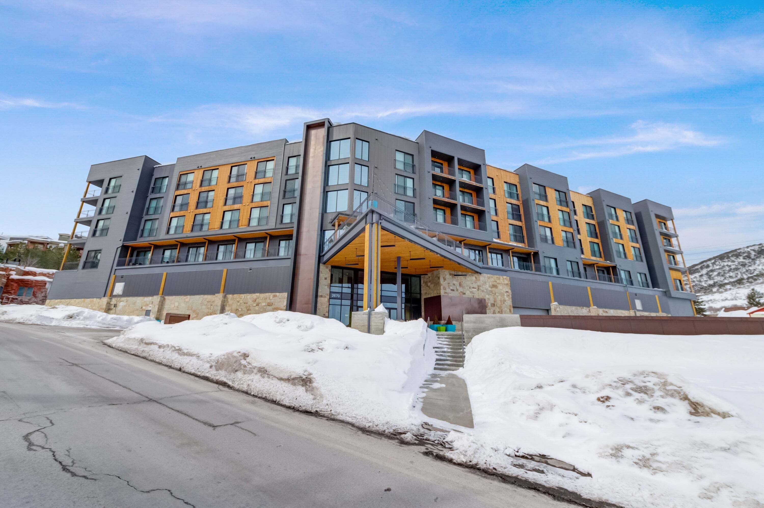 A multi-story hotel with a modern design, featuring a prominent entrance with a covered walkway.