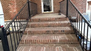 A brick staircase with black railings leading to a door. - Lakeside Retreat: Peaceful Jordan Lake Getaway (New Hill)
