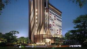 A modern hotel with a unique architectural design, featuring a prominent vertical element and a well-lit entrance. - Fave+ Hotel Lampung (Bandar Lampung)