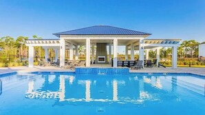 A pool with a covered pavilion, lounge chairs, and a clear blue sky. - Perdido Bayside Retreat Near Beach! Pool, Dock, Pickleball (Pensacola)