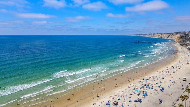 A beach with a pier extending into the ocean, sandy shore, and clear skies. - New! La Jolla Shores 2BD with Pool- Walk to Beach! (La Jolla)