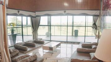 Deluxe Villa | Living area | 32-inch LED TV with cable channels