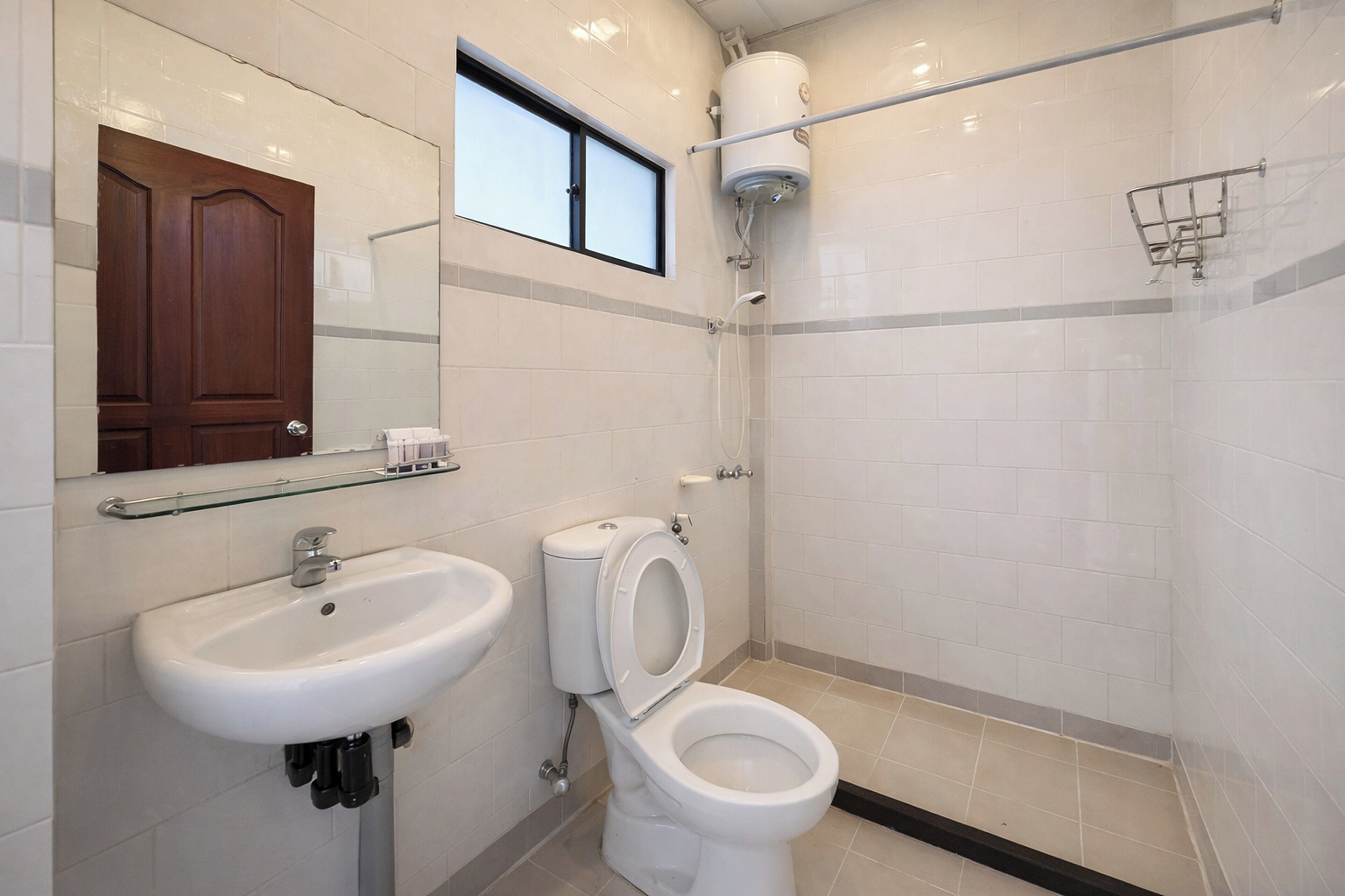 A bathroom with a sink, toilet, and shower.