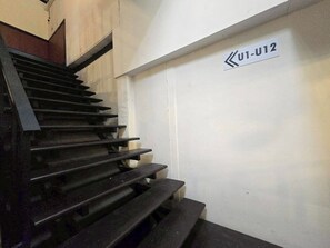 A staircase with a sign indicating direction. - Nearthepark Backpack Hostel Night Bazaar (Chiang Mai)