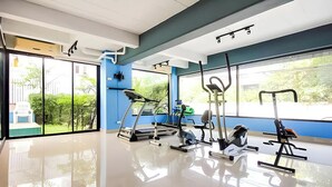 A gym with exercise equipment, large windows, and a clean, modern design. - Chill Guest (Bangkok)