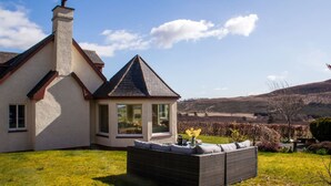 A house with a large garden, a conservatory, and a view of the countryside. - Little Balloch Angus Glens (Kirriemuir)