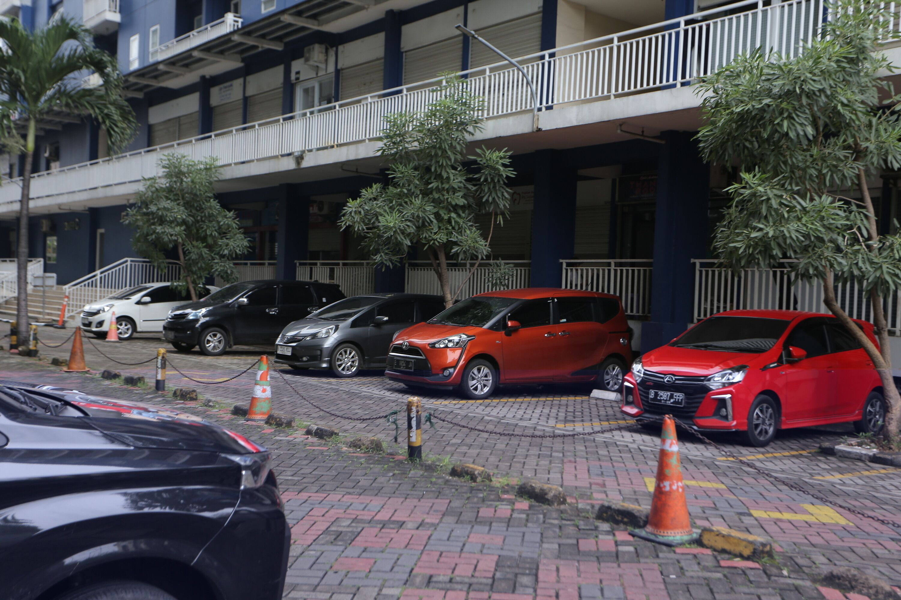 A multi-story building with a covered parking area.