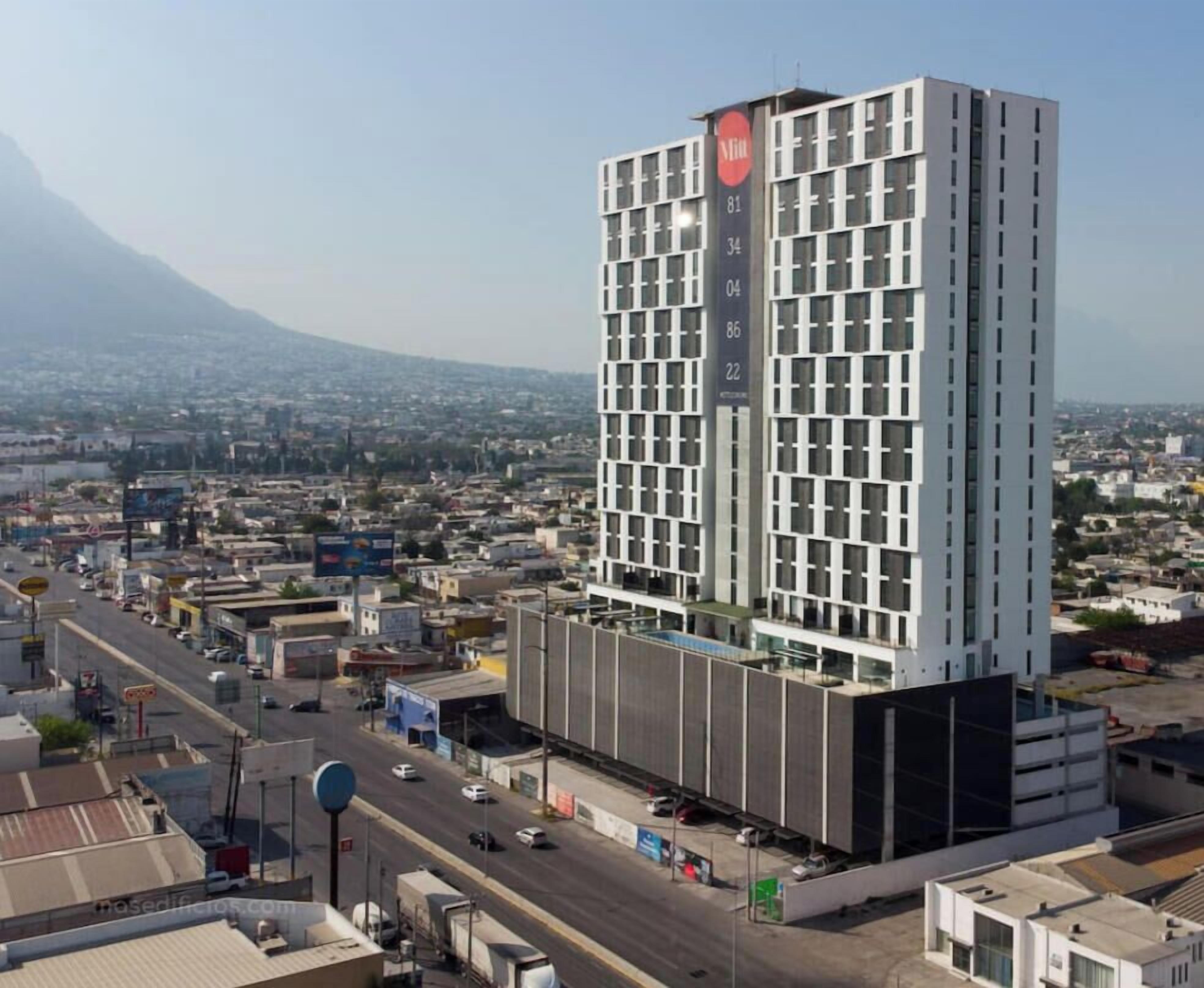 Un grand hôtel au design moderne, qui se distingue par un logo bien visible sur sa façade.
