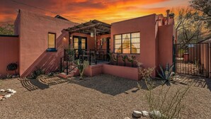 A house with a patio, a covered area, and a view of the sky.