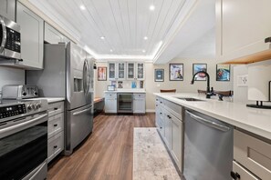 A modern kitchen with stainless steel appliances, a built-in oven, and a dishwasher. - Pineside Hideaway - N Conway, Story Land, Mt Washington, Perfect Location! (Bartlett)