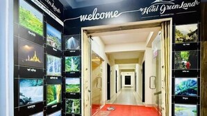 A hotel entrance with a red carpet, a 'welcome' sign, and a hallway leading to rooms. - Hotel Green Land Bandarban (Bandarban)