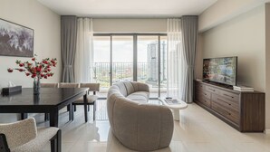 A modern living room with a sofa, dining table, and TV. - Nice stay next to Thao Dien area, 3brs, 5min to MRT, central (Thành phố Hồ Chí Minh)