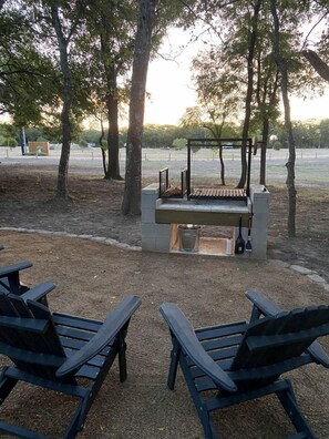 A park with a grill and seating area.