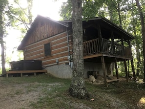 A log cabin with a deck and hot tub. - Enchanting Log Cabin in the Woods just Outside of Gatlinburg, Tennessee (Sevierville)