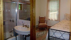 A bathroom with a glass shower enclosure, a sink, and a chair. - Lovely Cottage Getaway in the Mountains near Phoenicia, New York (Chichester)