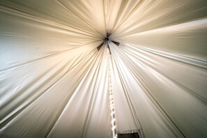 A tent-like structure with a central pole and evenly spaced lines radiating outward.