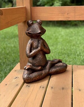 A wooden bench with a snake sculpture.