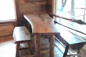 A rustic wooden interior with a bench and a table.
