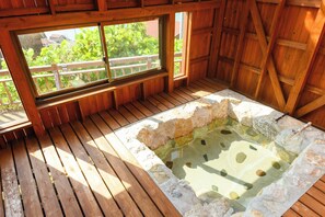 A wooden deck with a hot tub, wooden walls, and a window overlooking greenery. - WORKHOBBY Wakayama Yura (Yura)