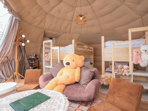 A tented accommodation with bunk beds, a large teddy bear, and a cozy seating area. - yamagata glam (Murayama)